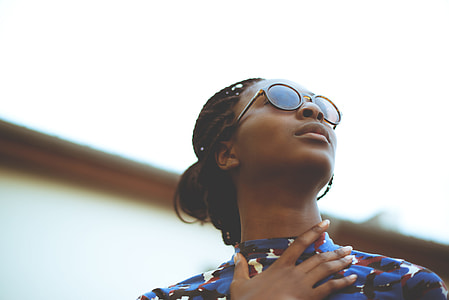 close-up photography of woman wearing brown-framed eyeglasses during daytime thumbnail