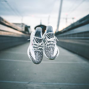 shallow photography of of black adidas Yeezy Boost 350 v2 thumbnail