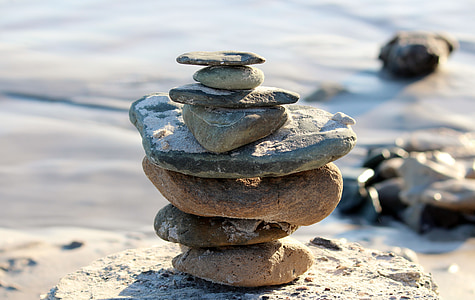 brown stone stack near body of water thumbnail
