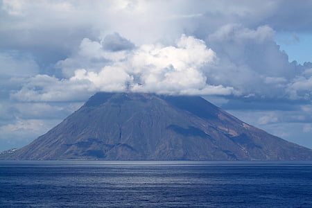 mountain range near surrounded by water thumbnail
