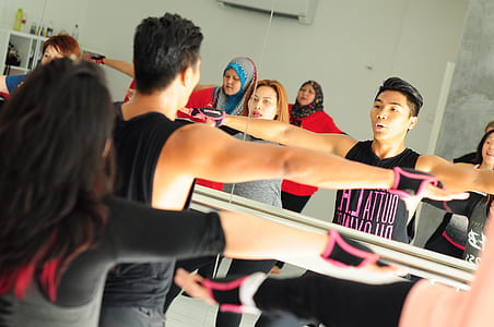 people performing exercise in room thumbnail