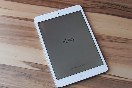 white iPad on brown wooden board thumbnail
