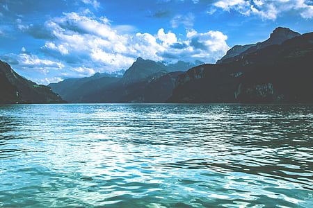 body of water near rock formation landscape photograph thumbnail