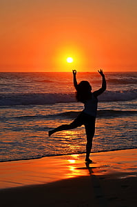 silhouette photography of woman on seashore thumbnail