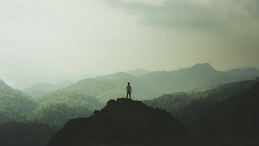 person standing at the top of hill thumbnail