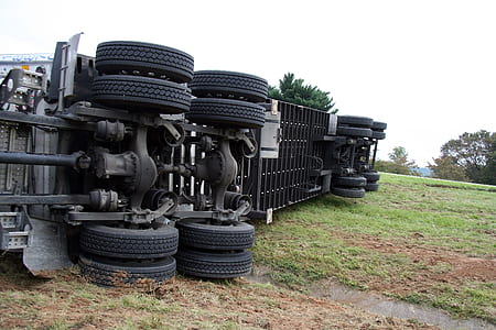 flipped gray truck on green grass during daytime thumbnail
