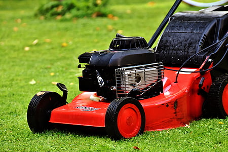 photo of black and red push lawn mower on grass field thumbnail