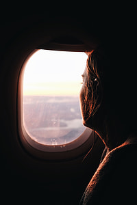 woman looking beside plane window thumbnail