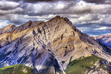 photo of mountain under cloudy sky thumbnail