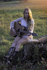 woman wearing white floral long-sleeved dress while playing acoustic guitar thumbnail