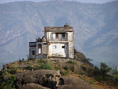 white and gray concrete house on hilltop during daytime thumbnail