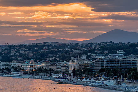 white building near body of water during golden hour thumbnail