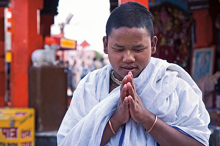 man wearing white scarf while praying during daytime thumbnail