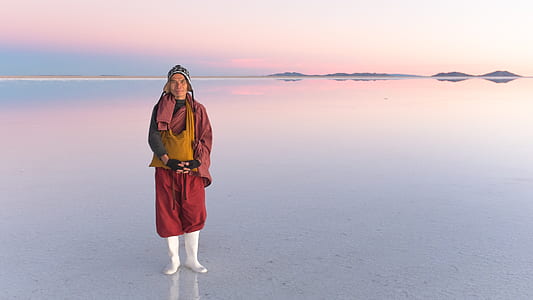person standing on salar de uyuni during daytime thumbnail