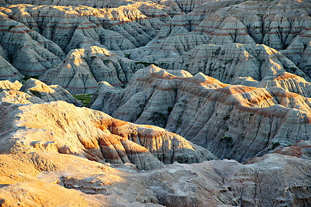 This is a view at the Badlands National Park at evening just before sunset. Colored bands can be seen in the rock formations. thumbnail