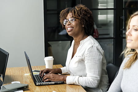 Two Women Sitting Near Table thumbnail