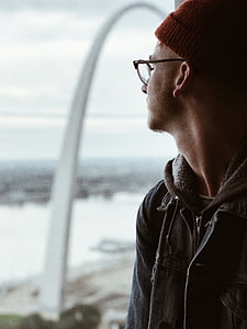 selective focus of man in gray zip-up hooded jacket during daytime thumbnail