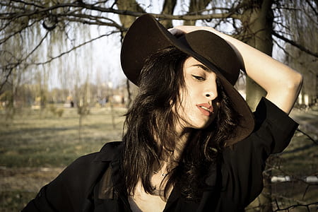 focus photo of woman wearing black hat thumbnail
