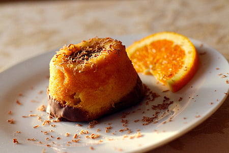 plate of orange chocolate pastry beside slide orange citrus fruit thumbnail