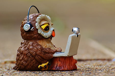 brown and white ceramic owl wearing black headphones figurine thumbnail
