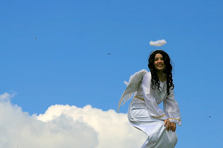 angel sitting on cloud under clear sky thumbnail