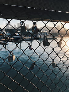 stainless steel padlocks on cyclone fence thumbnail