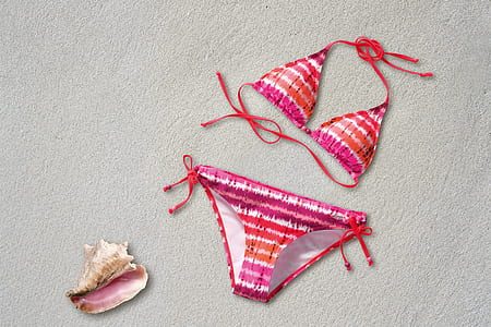 women's pink and orange striped bikini on sand thumbnail