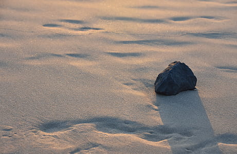 closeup photo of black stone on sow ground thumbnail
