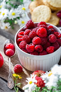 pile of raspberry in white ceramic bowl on table thumbnail