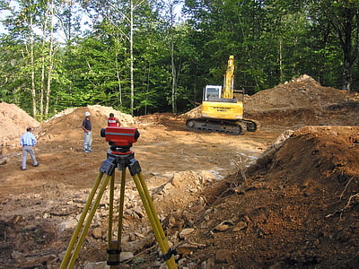 three men standing near excavator thumbnail