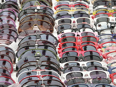 assorted-color-and-type sunglasses on table thumbnail
