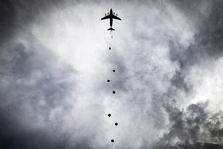 silhouette of airplane under cloudy sky thumbnail