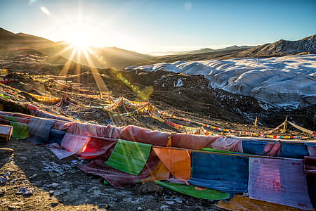 Assorted-color Flags on Mountain during Sunrise thumbnail