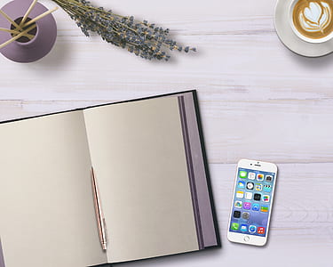 silver iPhone 6 turned-on beside book page thumbnail