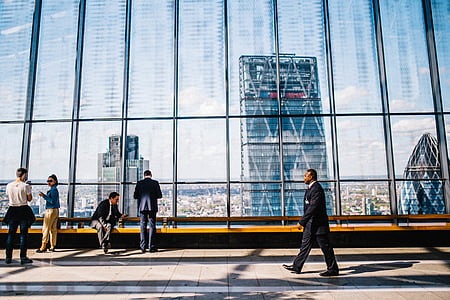 person walking near people beside ledge thumbnail