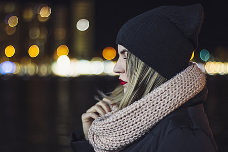 woman wearing black knit cap holding gray lace scarf thumbnail
