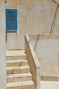 gray concrete stairs near blue window at daytime thumbnail