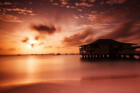 gray wooden house during sunset thumbnail