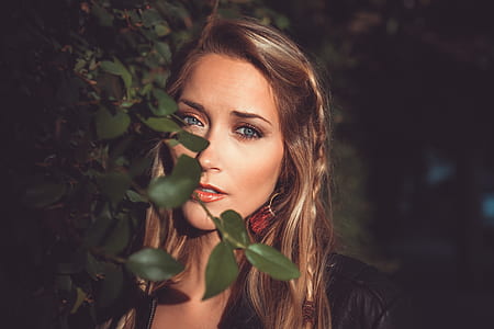 brown-haired woman standing near the green leafed plant thumbnail