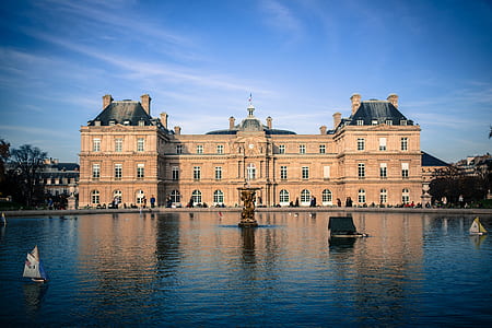 brown mansion and body of water thumbnail