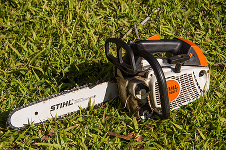white Stihl gas chainsaw on grass thumbnail