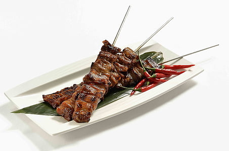 grilled meat served on white ceramic plate thumbnail