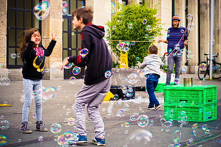 children playing bubbles during daytime thumbnail