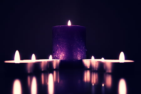 purple candle on black desk thumbnail