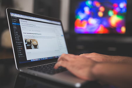 person's hands on gray and blac laptop on black table thumbnail