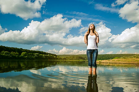 woman wearing white shirt standing in water thumbnail