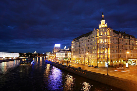 lighted building near body of water thumbnail