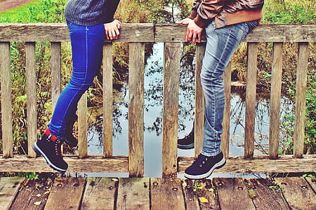 two person on bridge near body of water thumbnail