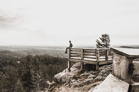 man sitting on mountain dock thumbnail