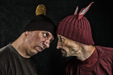 two men wearing red and black knitted caps thumbnail